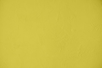 Saturated yellow colored low contrast Concrete textured background with roughness and irregularities. 2020, 2021 color trend.