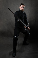 A man in a scary mask with a beard with a skid swords. Historical European Martial Arts, armor and...