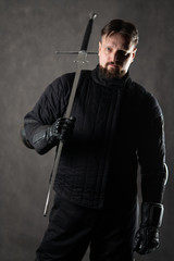 A man with a beard with a sword. Historical European Martial Arts, armor and weapons for practice....