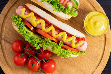 Hot dogs on wooden background. Top view, food flat lay. Fast food concept