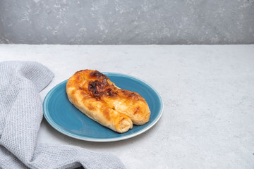 Banitsa (banitza or banica) traditional bulgarian dish on neutral concrete background, copy space