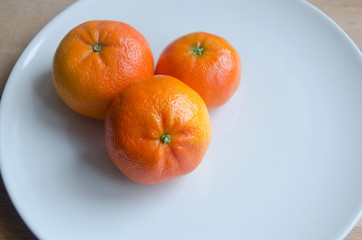 Tangerines on white plate