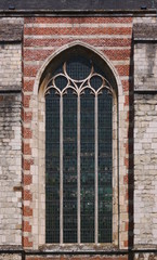 Pointed ogive arch with gothic window at the brick facade of Goes city church in the Netherlands