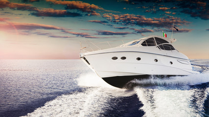 Luxurious motor boat sailing the sea at sunset - 330850736