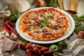 Flatlay of Italian pizza on wooden background. Rustic homemade pizzas with salami, bacon,  cheese, eggs and raw vegetables on shabby wooden background. Healthy vegetarian fungi pizza