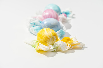 A row of freshly painted Easter eggs on a white background. Close-up.
