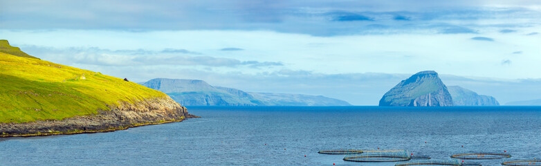 Faroe Islands Panoramic View, Typical Scandinavian Houses And Salmon farm In Faroe Islands © Ilgov