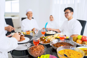 Fototapeta na wymiar Blurred portrait of muslim family eating happily