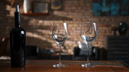 Wine glasses and a bottle of red wine