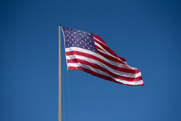 American flag waving in blue sky. Memorial Day