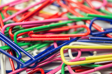 Stationery plastic multicolored paper clips. Macro photography