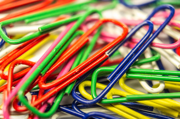 Stationery plastic multicolored paper clips. Macro photography