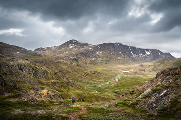 Obraz premium Valley with a river among steep mountain slopes
