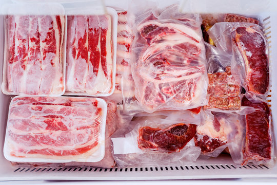 Top down view of red meat package piles in a box