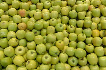 Fresh green apples on the market stall