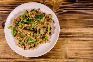 Risotto with mushrooms and paesley in a plate. Top view