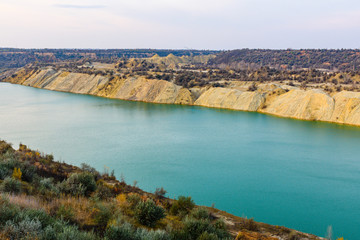 Lake with sandy bank in the abandoned coal quarry