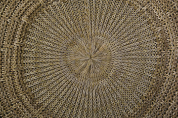 Close-up on a knitted beige thing. The circular texture. The trend for natural materials. Perfect background