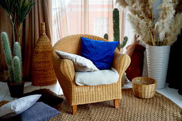 A chair and a rug made of rattan. Natural material. Pampas grass in a vase. Eco design.