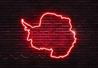 Neon sign on a brick wall in the shape of Antarctica.(illustration series)
