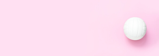 White volleyball leather ball on pink background. Top view.