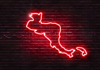 Neon sign on a brick wall in the shape of Central America.(illustration series)