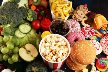 healthy or unhealthy food. Concept photo of healthy and unhealthy food. Fruits and vegetables vs donuts,sweets and burgers
