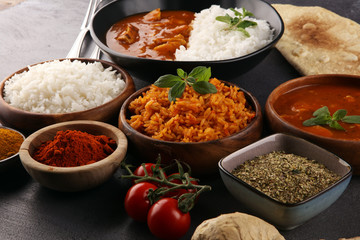Chicken tikka masala spicy curry meat food in pot with rice and naan bread. indian food on table