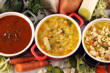Set of soups from worldwide cuisines, healthy food. Broth with noodles, beef soup and broth with marrow dumplings. All soups with healthy vegetables on table