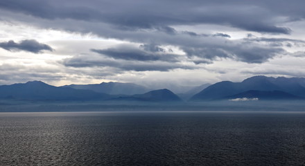 Thunderclouds and rain clouds over the coastline of the Strait of Juan de Fuca. Pacific Ocean.