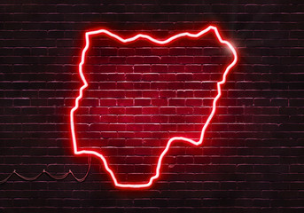 Neon sign on a brick wall in the shape of Nigeria.(illustration series)