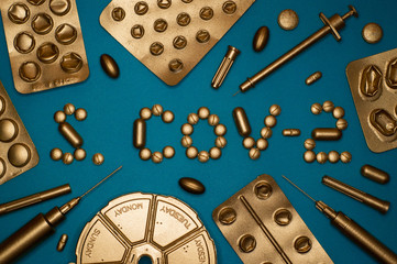 sars cov 2 word and blister packs on blue background