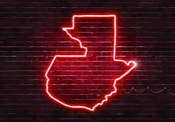 Neon sign on a brick wall in the shape of Guatemala.(illustration series)