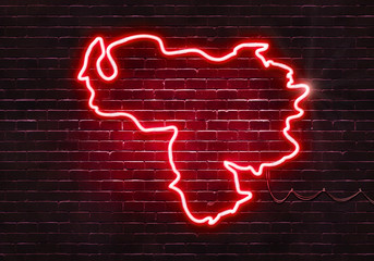 Neon sign on a brick wall in the shape of Venezuela.(illustration series)