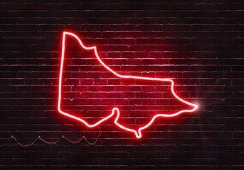 Neon sign on a brick wall in the shape of Victoria.(illustration series)