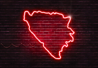 Neon sign on a brick wall in the shape of Bosnia and Herzegovina.(illustration series)