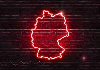 Neon sign on a brick wall in the shape of Germany.(illustration series)