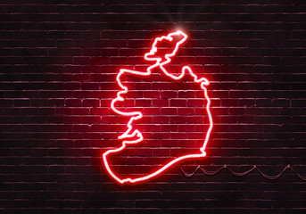 Neon sign on a brick wall in the shape of Ireland.(illustration series)