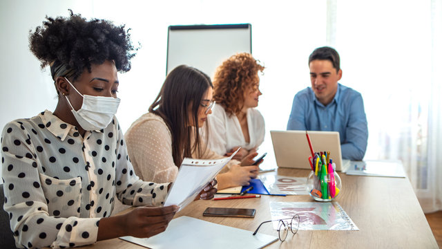 Adult woman wearing a protective mask to protect herself from viruses. Stressed female corporate employee having surgical mask. Beautiful business woman having flu illness