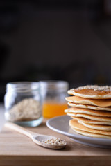 Young female chef in kitchen at home preparing american pancakes. Healthy eating