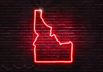 Neon sign on a brick wall in the shape of Idaho.(illustration series)