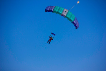 Colored Parachute in the Blue sky on skydiver Club