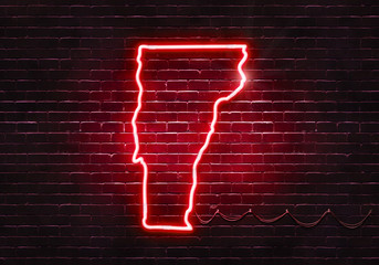 Neon sign on a brick wall in the shape of Vermont.(illustration series)