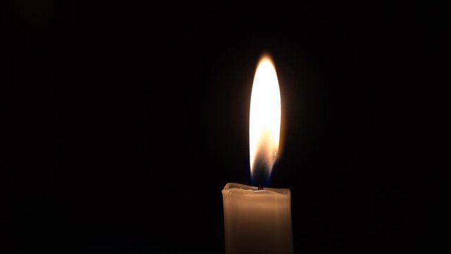 Simple candle in the dark with some flickers on background