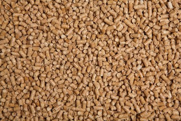 Wooden pellets. Alternative heating in winter. Texture of house pellets for heating. Ecologically energy. Wood background.