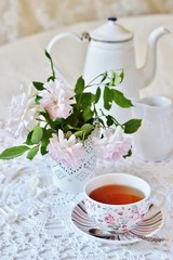 A tea party  in the style of Shabby Chic. tea in the beautiful tea steam with a pattern 