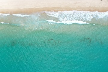 Fototapeta na wymiar coastline of sandy bay turquoise sea and white sand Hainan Yalong Bay