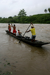 person uses canoe to cross cachoeira river