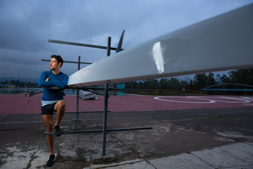 portrait of a rowing man and his boat 