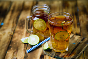 iced tea cocktail with strong drinks, wood background